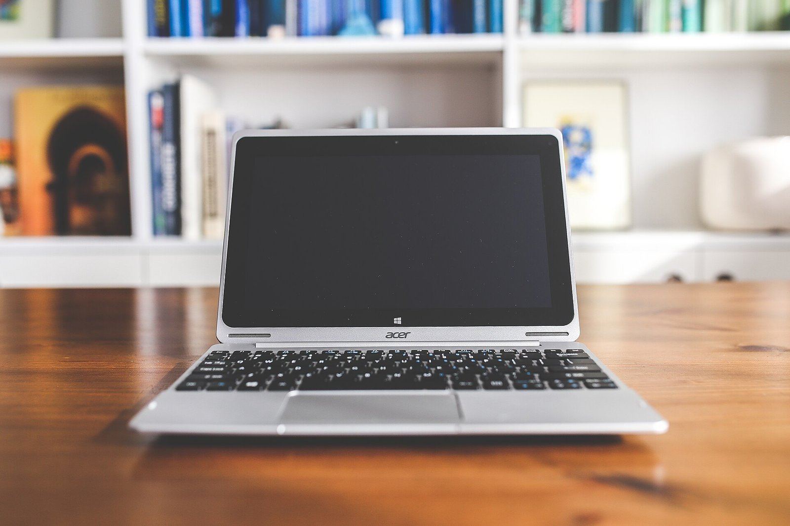 Desk, laptop and notebook representing a repeatable working system